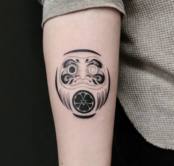 mẫu xăm cho khách nữ hình daruma gắn cỏ ba lá mong mọi thứ luôn thuận lợi