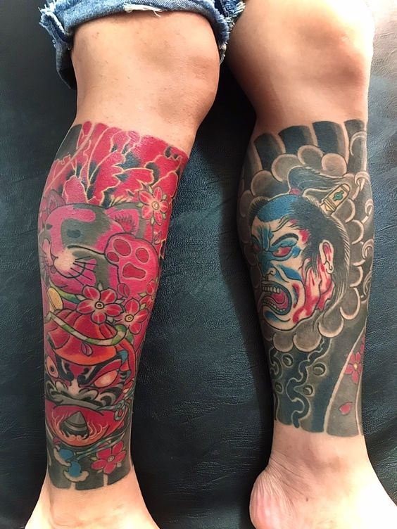 mẫu xăm mặt quỷ phản diện với mặt daruma hai bên bắp chân